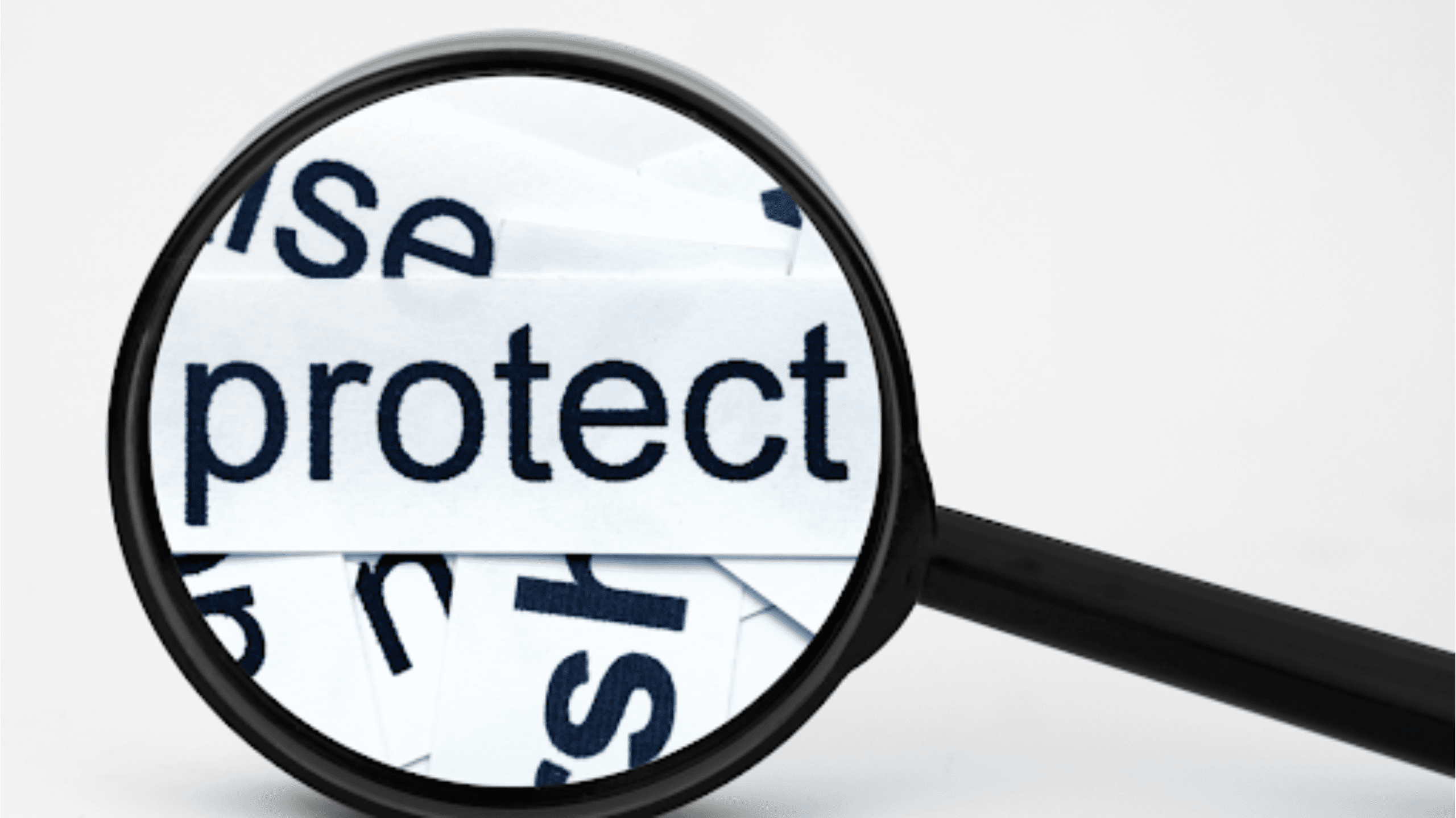 A magnifying glass focusing on the word "protect" among scattered text, emphasizing the importance of protection and preservation.