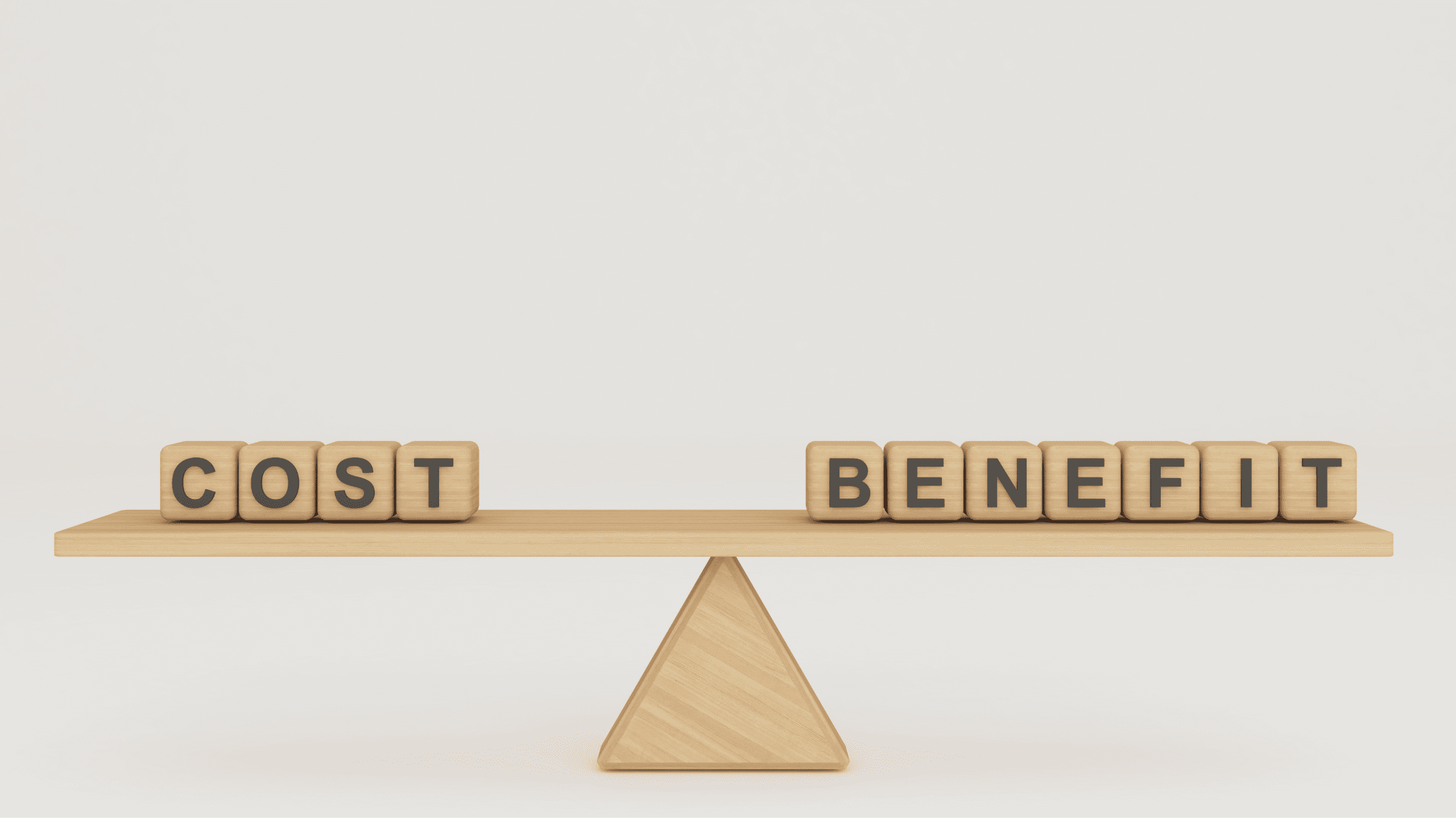 Wooden blocks spelling cost and benefit sit balanced on a wooden seesaw, symbolizing a cost-benefit analysis of vinyl seawalls.