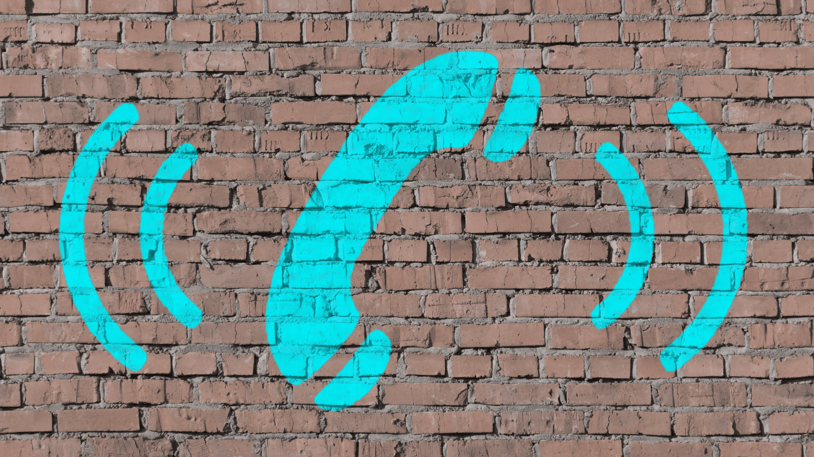 A brick wall with a bright blue painted phone icon, symbolizing the need to call for professional help regarding seawall sinkhole issues.